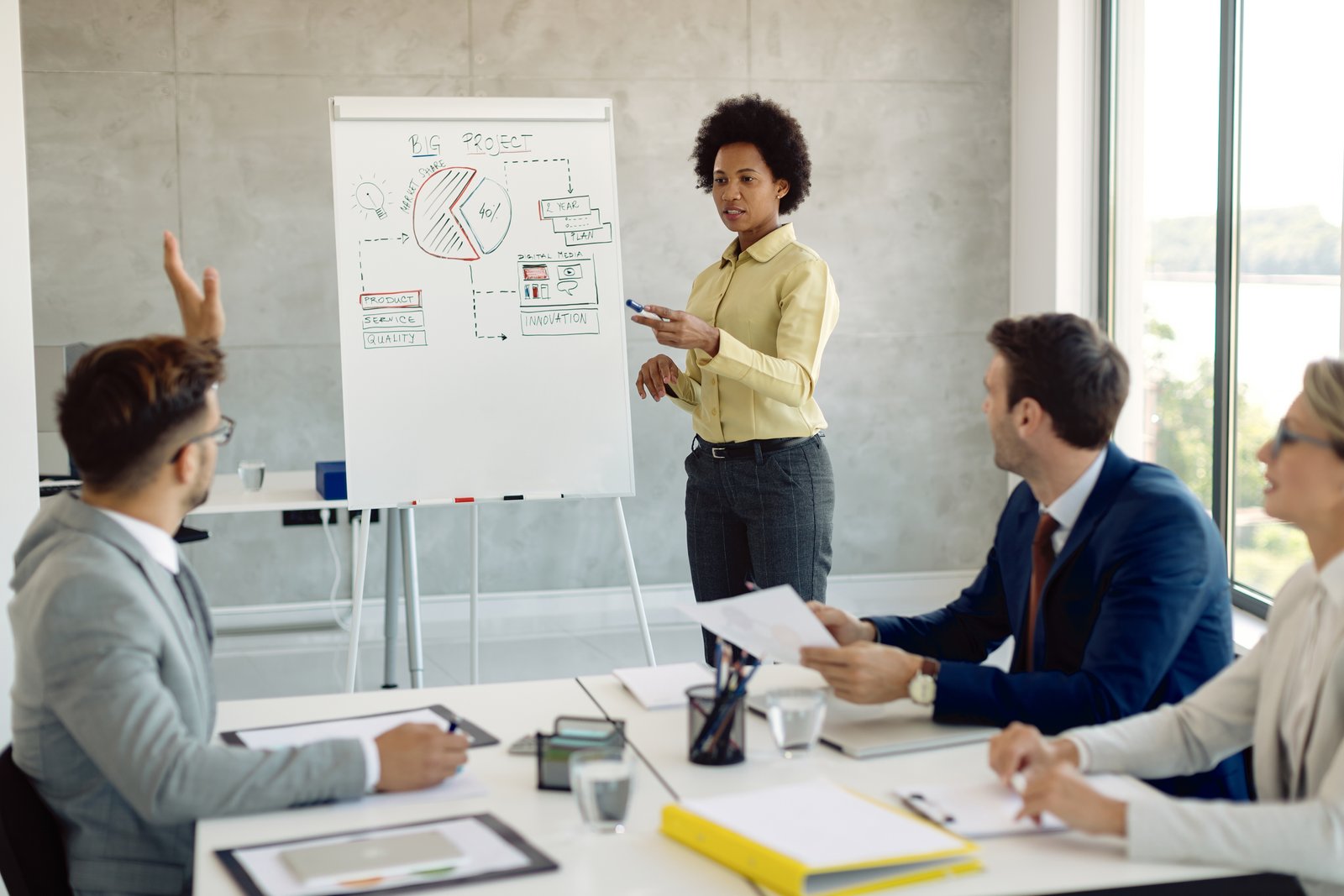 Cleaning staff in protective gear sanitizing an office space